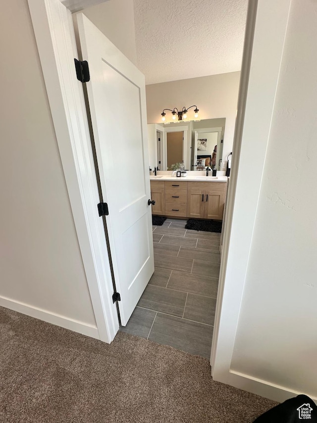 634 E Otto Ln, Grantsville, UT 84029 - bathroom featuring vanity, carpet, baseboards, and a textured ceiling