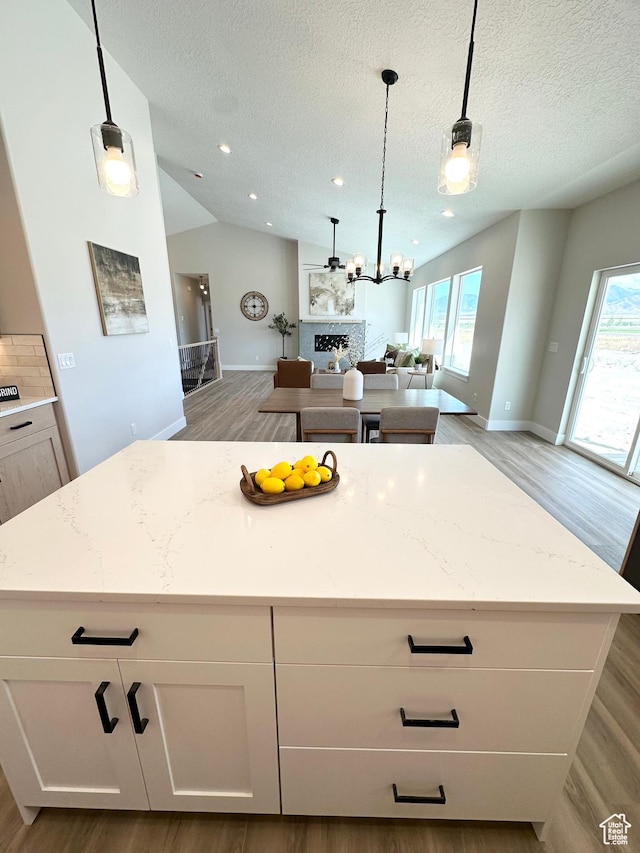 634 E Otto Ln, Grantsville, UT 84029 - kitchen featuring plenty of natural light, a kitchen island, open floor plan, and vaulted ceiling