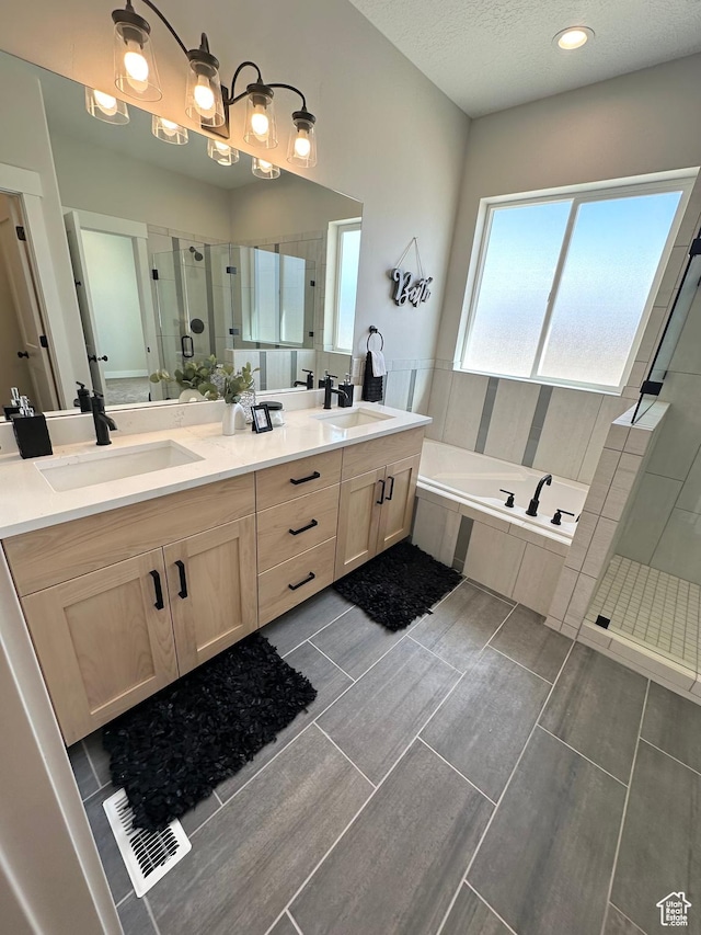 634 E Otto Ln, Grantsville, UT 84029 - bathroom with double vanity, a stall shower, a garden tub, and a sink