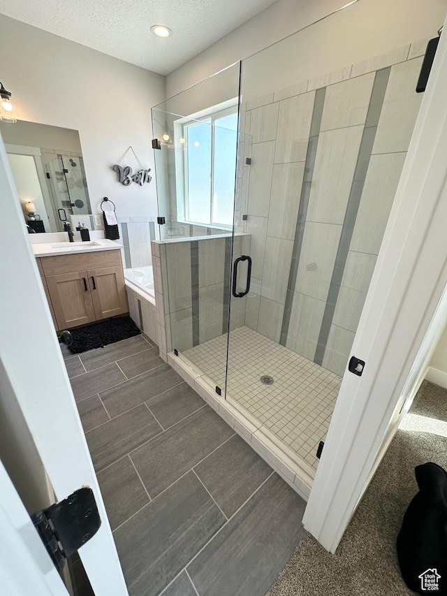 634 E Otto Ln, Grantsville, UT 84029 - full bath featuring vanity, a shower stall, a garden tub, and a textured ceiling