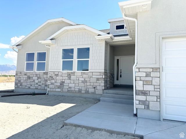 634 E Otto Ln, Grantsville, UT 84029 - property entrance featuring a mountain view, stone siding, and an attached garage