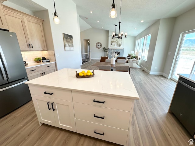 634 E Otto Ln, Grantsville, UT 84029 - kitchen featuring light wood finished floors, backsplash, lofted ceiling, and freestanding refrigerator