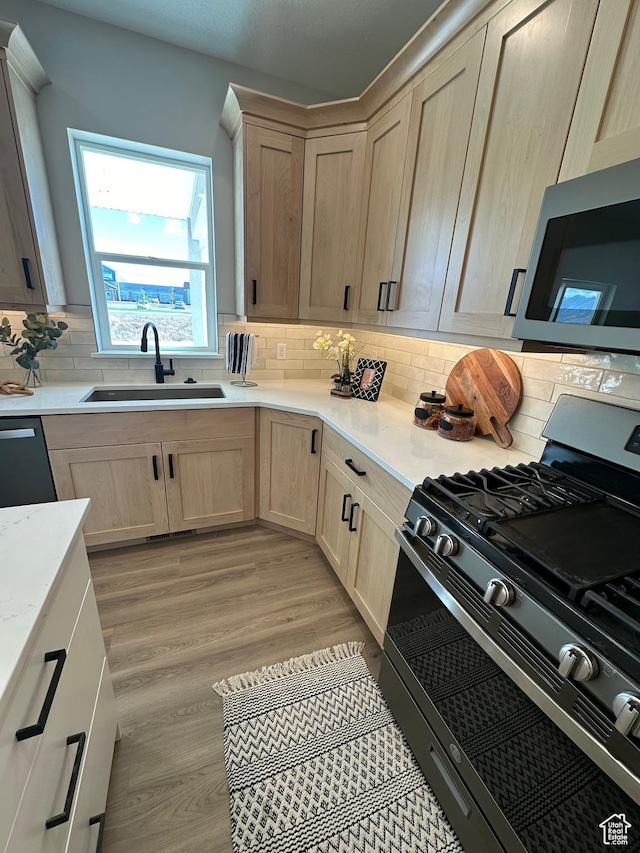 634 E Otto Ln, Grantsville, UT 84029 - kitchen with a sink, decorative backsplash, light brown cabinetry, and stainless steel appliances