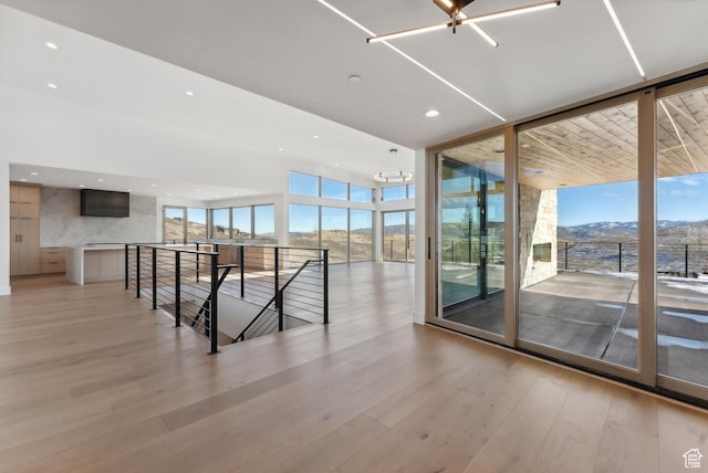 7702 N Fire Ring Glade, Park City, UT 84098 - interior space with a mountain view, light wood-type flooring, floor to ceiling windows, and a notable chandelier