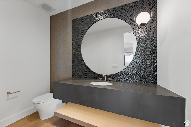7702 N Fire Ring Glade, Park City, UT 84098 - bathroom featuring hardwood / wood-style flooring, decorative backsplash, toilet, and vanity