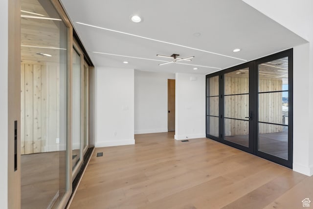 7702 N Fire Ring Glade, Park City, UT 84098 - empty room with french doors, expansive windows, light hardwood / wood-style flooring, and ceiling fan