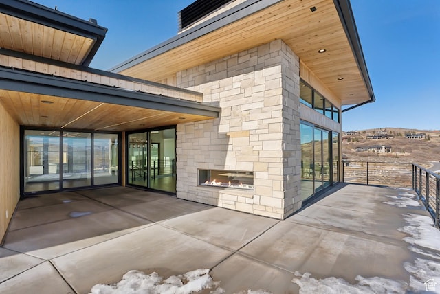 7702 N Fire Ring Glade, Park City, UT 84098 - view of patio featuring an outdoor stone fireplace and a balcony