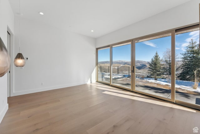 7702 N Fire Ring Glade, Park City, UT 84098 - spare room featuring a mountain view and light wood-type flooring