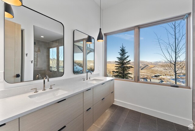 7702 N Fire Ring Glade, Park City, UT 84098 - bathroom with tile patterned flooring, vanity, a mountain view, and a wealth of natural light