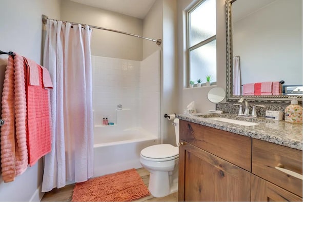 full bathroom featuring shower / bath combo with shower curtain, vanity, and toilet