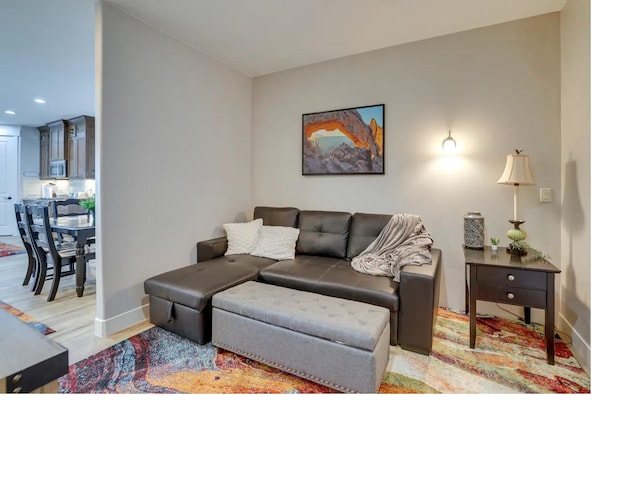 living room featuring baseboards and light wood-style floors