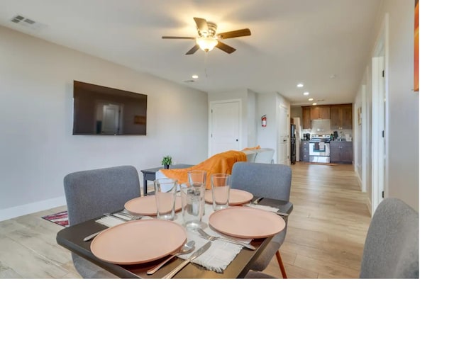 dining room featuring baseboards, light wood-type flooring, visible vents, and recessed lighting