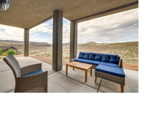 view of patio with a mountain view and an outdoor hangout area