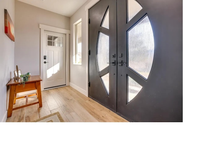 entryway with french doors, baseboards, and wood finished floors