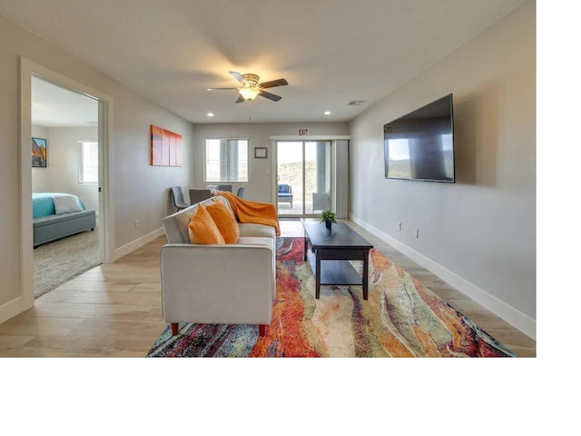 living area with light wood-style floors, ceiling fan, baseboards, and recessed lighting