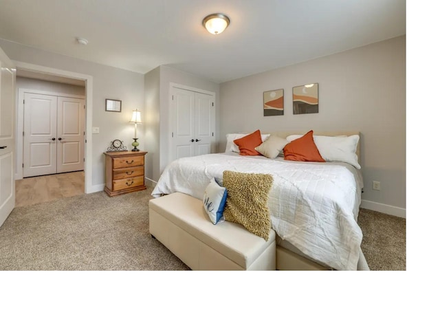 bedroom featuring a closet, baseboards, and carpet flooring