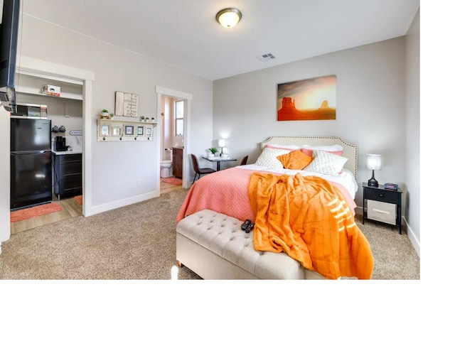 bedroom with baseboards, visible vents, ensuite bath, and carpet flooring