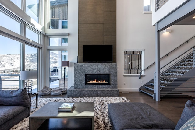2752 W High Rd Unit 1501, Park City, UT 84098 - living room featuring a high ceiling, a high end fireplace, and dark wood-type flooring