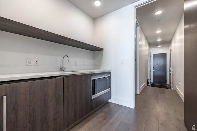 2752 W High Rd Unit 1501, Park City, UT 84098 - kitchen featuring dark brown cabinets, sink, built in microwave, and dark wood-type flooring