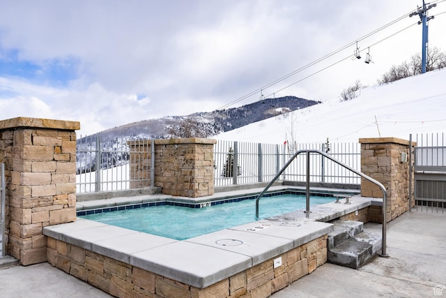 2752 W High Rd Unit 1501, Park City, UT 84098 - snow covered pool with a mountain view and a hot tub