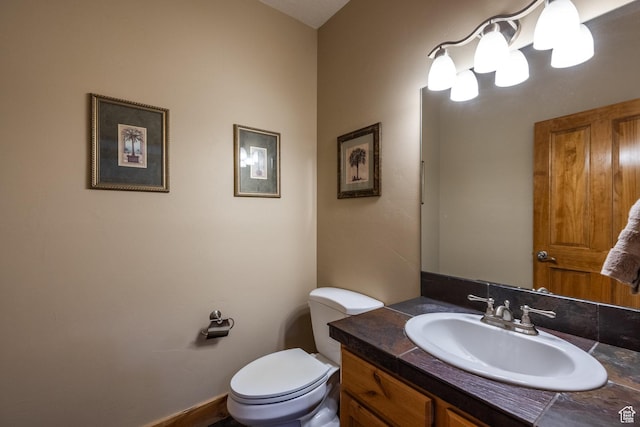 bathroom featuring toilet and vanity