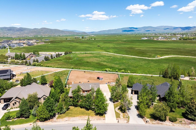 birds eye view of property with a rural view, a mountain view, and a residential view