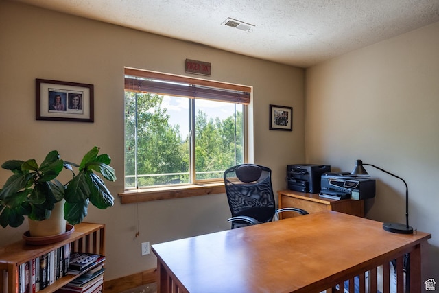 office featuring visible vents and a textured ceiling