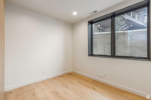 unfurnished room with visible vents, baseboards, plenty of natural light, and light wood-style floors