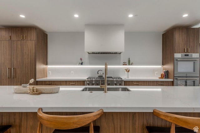1063 Lowell Ave Unit 1, Park City, UT 84060 - kitchen featuring stainless steel double oven, a kitchen breakfast bar, recessed lighting, and light stone counters