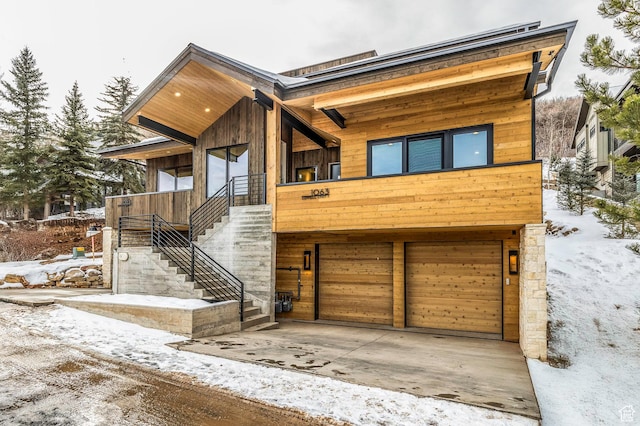modern home with stairs and an attached garage
