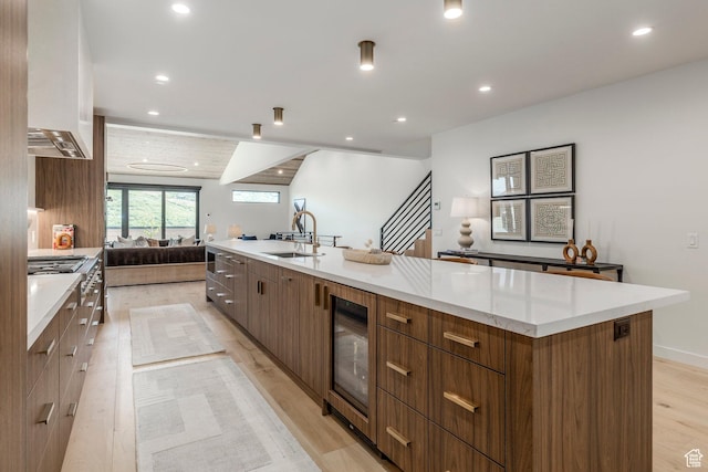 1063 Lowell Ave Unit 1, Park City, UT 84060 - kitchen with open floor plan, modern cabinets, wine cooler, light wood finished floors, and a large island with sink