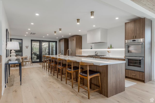 1063 Lowell Ave Unit 1, Park City, UT 84060 - kitchen featuring appliances with stainless steel finishes, modern cabinets, a spacious island, light wood-style floors, and recessed lighting