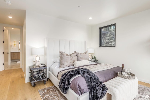 bedroom with light wood-style flooring, recessed lighting, and baseboards