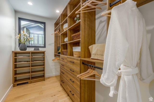 spacious closet featuring light wood-style flooring and visible vents