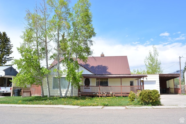 view of front of home featuring a garage and a carport
