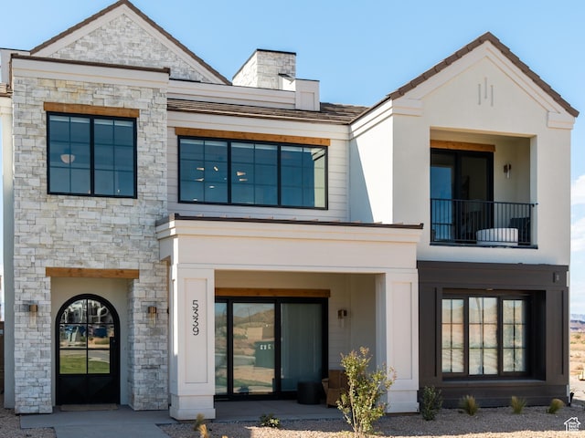 rear view of property with a balcony