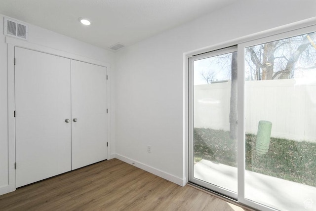 439 N 268 W Unit 4-18, Salt Lake City, UT 84103 - unfurnished bedroom with wood finished floors, access to outside, baseboards, a closet, and recessed lighting
