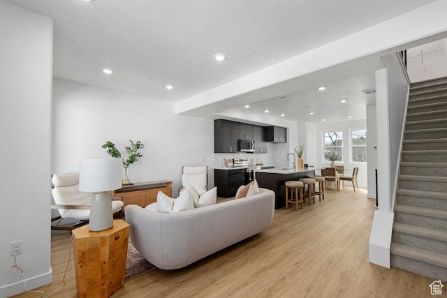 439 N 268 W Unit 4-18, Salt Lake City, UT 84103 - living room with light wood-style flooring, stairs, recessed lighting, and baseboards