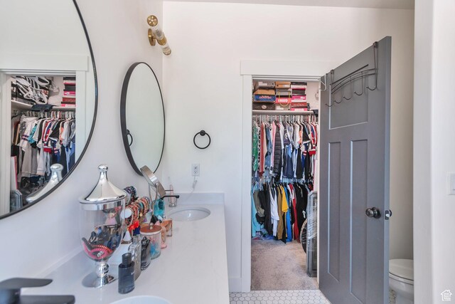 1118 E 1310 S, Garland, UT 84312 - full bath with a spacious closet, tile patterned floors, a sink, and toilet