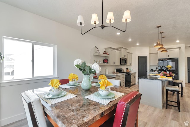 1118 E 1310 S, Garland, UT 84312 - dining area with a chandelier, a textured ceiling, light wood finished floors, and recessed lighting
