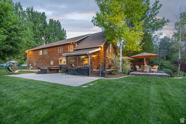 3383 Wild Mare Way, Heber City, UT 84032 - rear view of property with a hot tub, a patio area, log siding, and a lawn