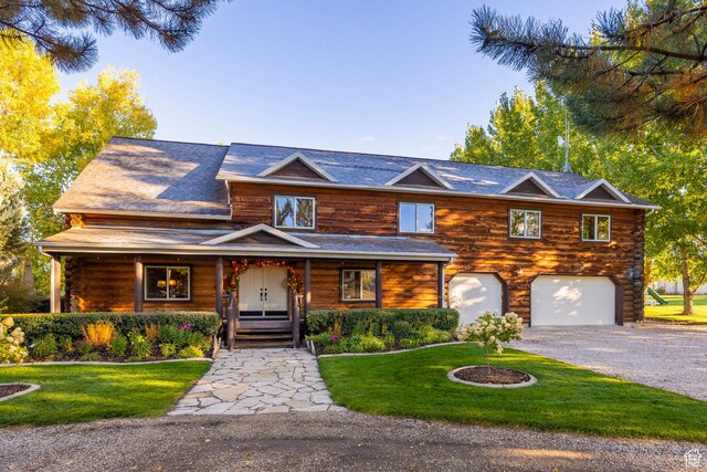 3383 Wild Mare Way, Heber City, UT 84032 - log cabin with a front lawn, driveway, a garage, a porch, and log exterior