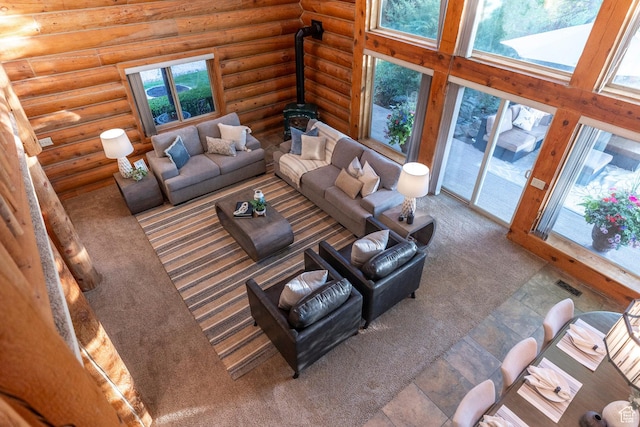 3383 Wild Mare Way, Heber City, UT 84032 - living room with carpet, healthy amount of natural light, a wood stove, log walls, and a towering ceiling
