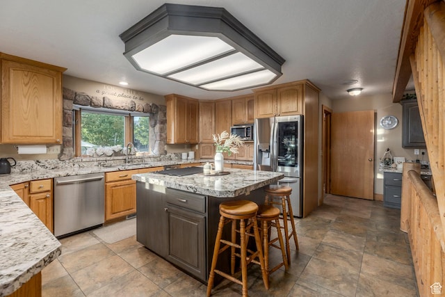 3383 Wild Mare Way, Heber City, UT 84032 - kitchen featuring stainless steel appliances, a sink, a kitchen island, a breakfast bar, and light stone countertops
