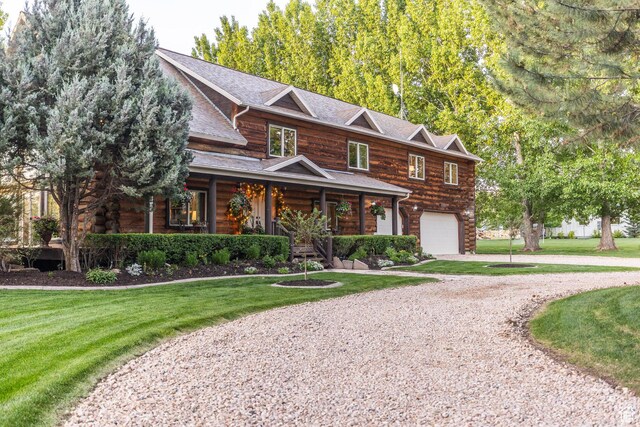 3383 Wild Mare Way, Heber City, UT 84032 - view of front of home featuring a porch, a garage, driveway, and a front yard