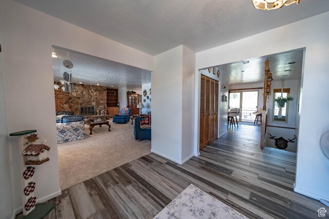 2317 N Hillside Dr, Wellington, UT 84542 - corridor featuring baseboards, wood finished floors, and a textured ceiling
