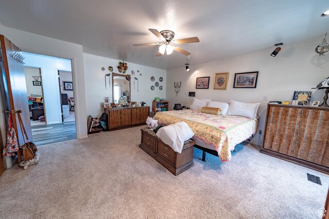 2317 N Hillside Dr, Wellington, UT 84542 - bedroom featuring ceiling fan, visible vents, and light carpet