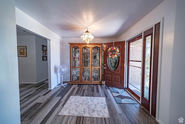2317 N Hillside Dr, Wellington, UT 84542 - foyer featuring baseboards, wood finished floors, and an inviting chandelier