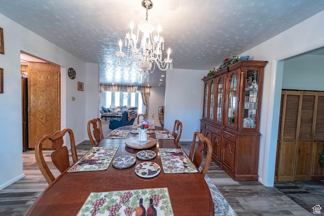 2317 N Hillside Dr, Wellington, UT 84542 - dining room with a chandelier, wood finished floors, and baseboards
