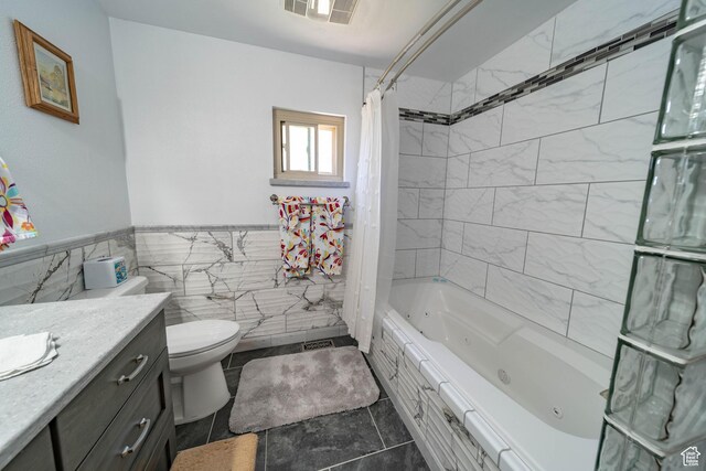 2317 N Hillside Dr, Wellington, UT 84542 - bathroom featuring vanity, tile walls, a wainscoted wall, visible vents, and a combined bath / shower with jetted tub